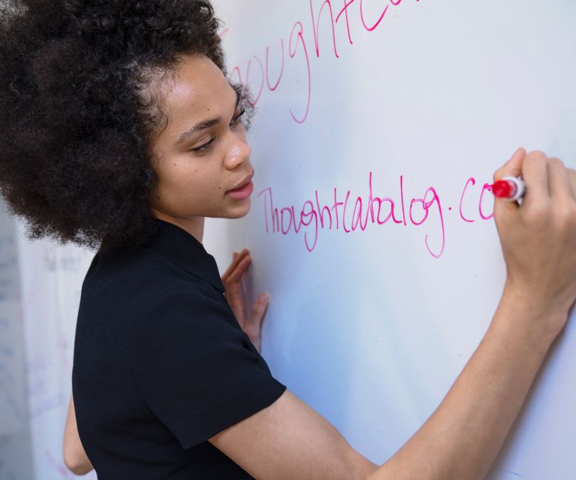Female writes on whiteboard